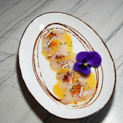 Citrus-dressed fish slices with flower.