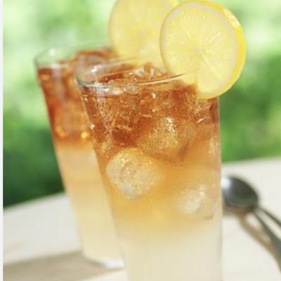 Two Arnold Palmer drinks, garnished with lemon slices.