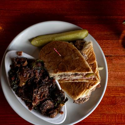 Cuban sandwich served with crispy brussels sprouts.