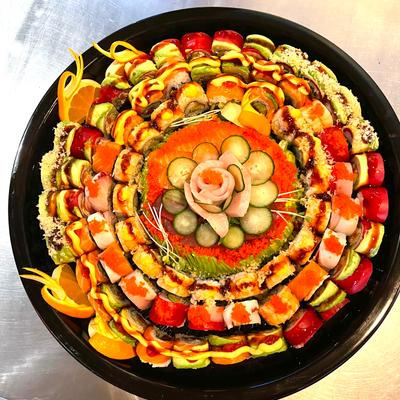 Round plate with assorted sushi pieces arranged in a circle, top view
