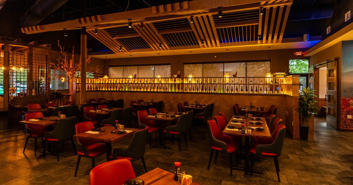 Dining area featuring distinctive wooden slat ceiling structures and warm ambient lighting