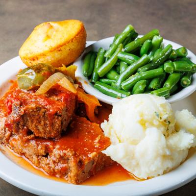 Meatloaf, with mashed potatoes and green beans.