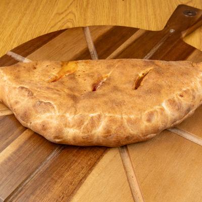 Calzone on a wooden board.