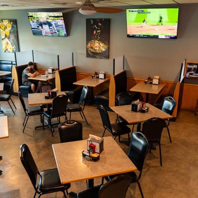 Dining area with booths, tables, and TVs.