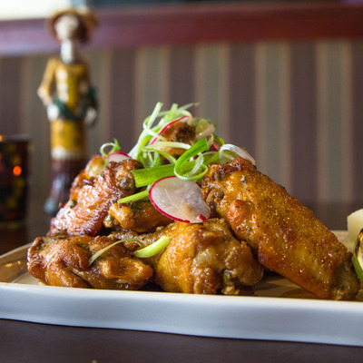 Fried chicken dish with a figurine in the back