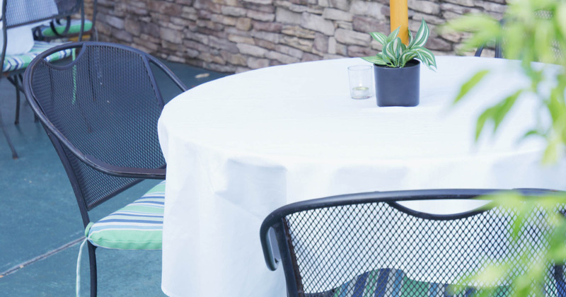 Outdoor seating area, table with white tablecloth, closeup