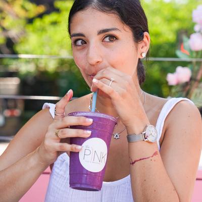 A guest enjoying a cup of  Acai-you smoothie.