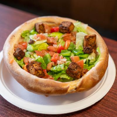 Bread bowl house salad, served, front view, closeup.