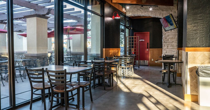 Interior, tables and chairs by a window side