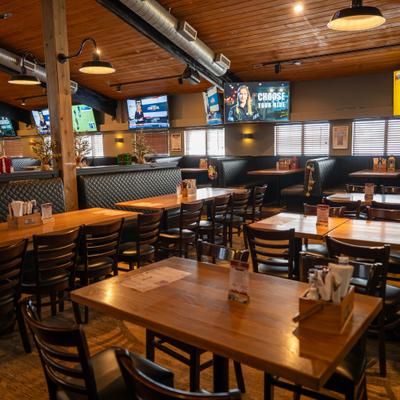 Interior with wood-paneled ceiling and a mix of booth and table seating.