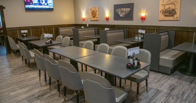 Interior, dining area, long table setup for eight, seating booths in the back