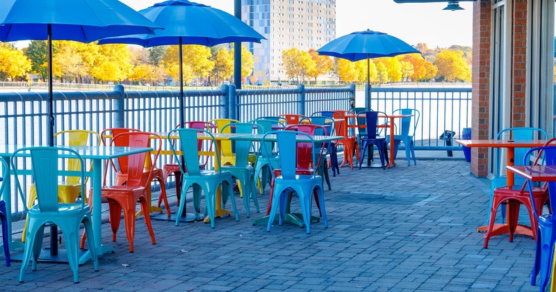 Outdoor seating area, tables and chairs with parasols