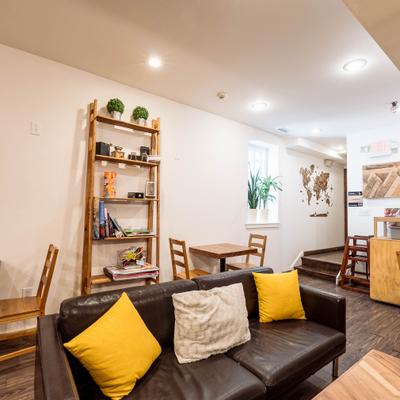 Cozy seating area featuring a dark brown leather sofa adorned with yellow pillows.