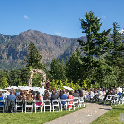 Guests with bride and groom and natural landscape in the back