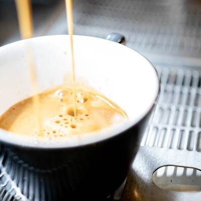 A coffee being poured from the machine.