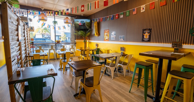 Interior with wooden tables and metal chairs in various colors