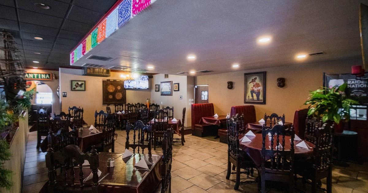Dining room with booths, tables, and colorful ceiling banners