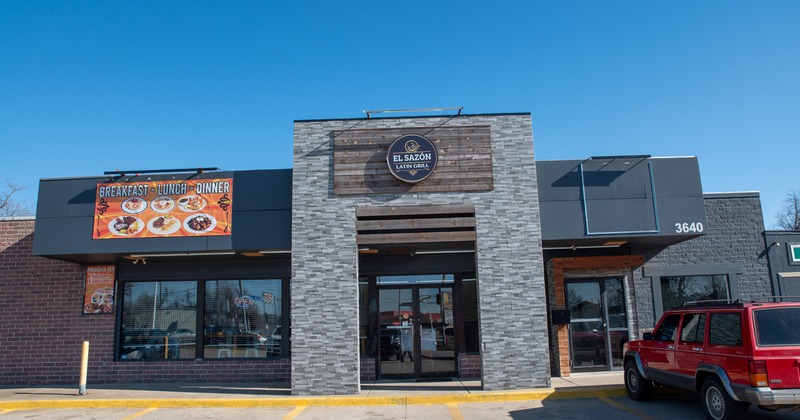 Exterior, front view to entrance of restaurant, parking lot