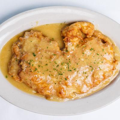 Chicken cutlets coated in flour and egg and fried with a lemon-butter sauce.