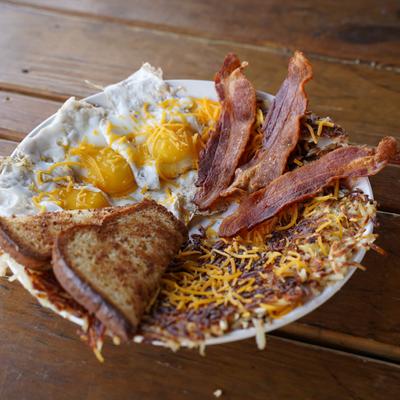 The Crows Nest breakfast plate with hashbrown, eggs, meat, cheddar, and toast.