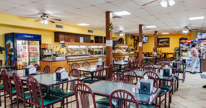 Interior with tables, chairs and a food service counter