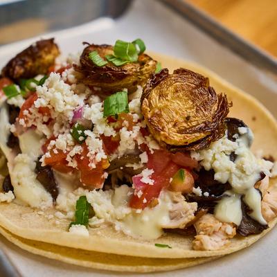 Crispy Brussels taco with mushrooms, pico, goat cheese, and caramelized onions.