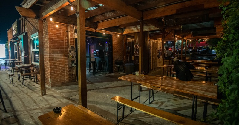 Covered patio, seating area with tables and benches