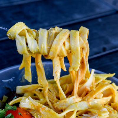 A mix of seafood and grilled meat with noodles