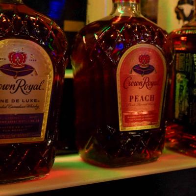 Liquor bottles displayed on a bar shelf.