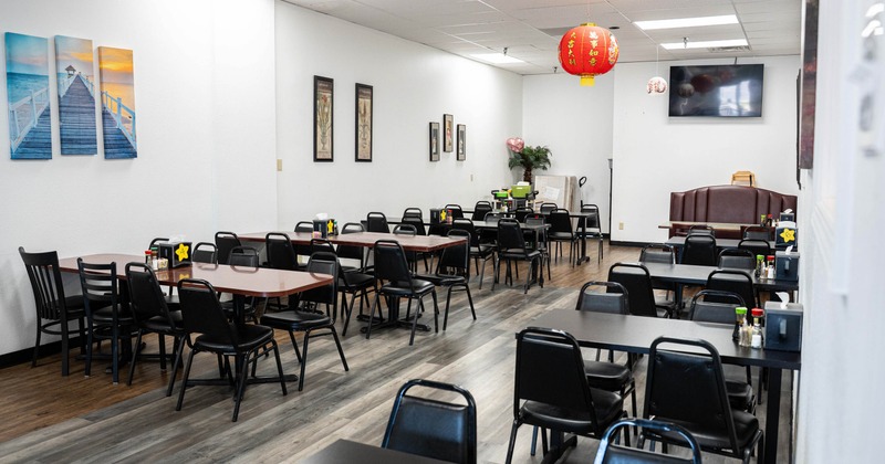 Interior with laminate wood flooring, black metal chairs, and a festive red lantern