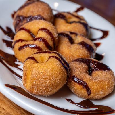Mini Donuts drizzled with chocolate.