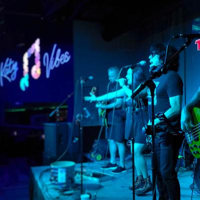 Band on stage performing live music.