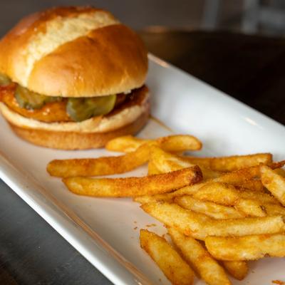 Spicy chicken sandwich served with fries on the side.