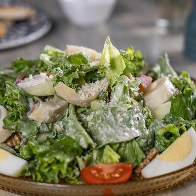 Insalata Fantasia lettuce, tomato, vegetables, hearts of palm, artichoke, prosciutto, Gruyere, walnuts, eggs.