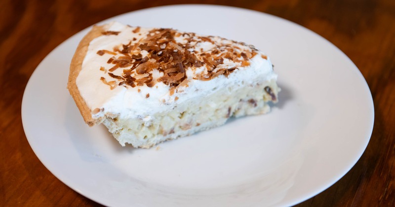 Slice of Coconut cake served on a plate