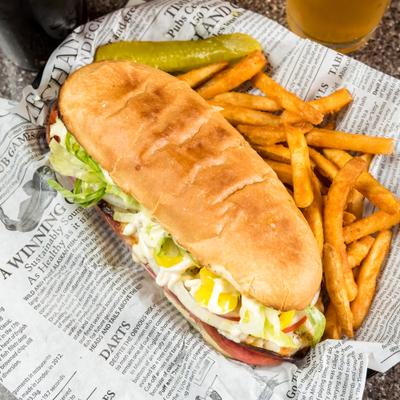 Ham, salami and pepperoni sub, with mozzarella, vegetables, dressing, mayo and a side of fries.