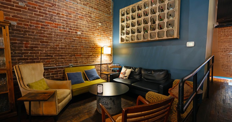 Interior, cozy lounge with exposed brick walls, armchairs and coffee table