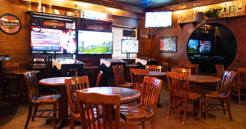 Interior - wooden tables and chairs, flat screen TVs on the wall