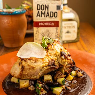 Grilled chicken served over grilled vegetables and mushrooms.