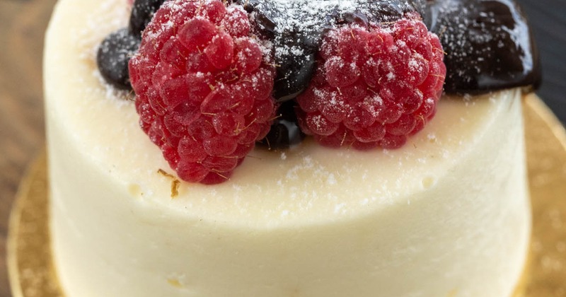 French Express Cake, topped with raspberries, glaze and sugar powdered