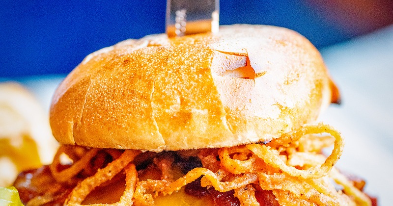 Salt + Stone Burger- Applewood smoked bacon, Swiss or cheddar, bacon aioli, onion straws, brioche bun