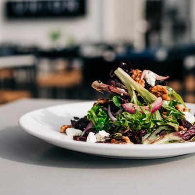 Beet salad with mixed greens, candied walnuts, cheese, craisins and red onions