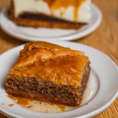 Baklava served on the table alongside slice of cake.