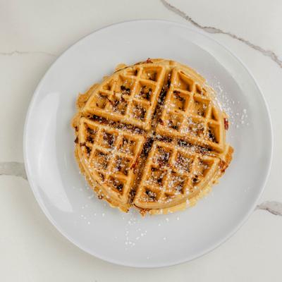 Bacon waffle dusted with powdered sugar.