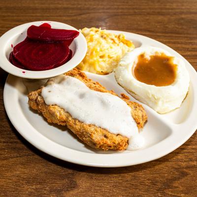 Fried chicken with white gravy, pickled beets. mashed potatoes, and mac and cheese.