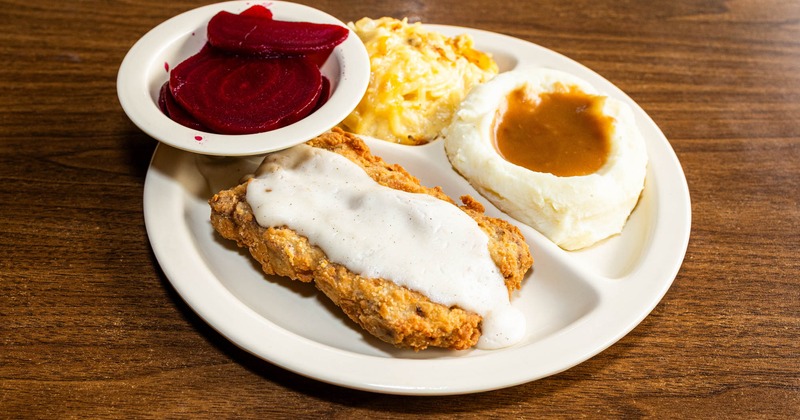 Southern chicken fried steak with beets, mashed potatoes, and macaroni and cheese