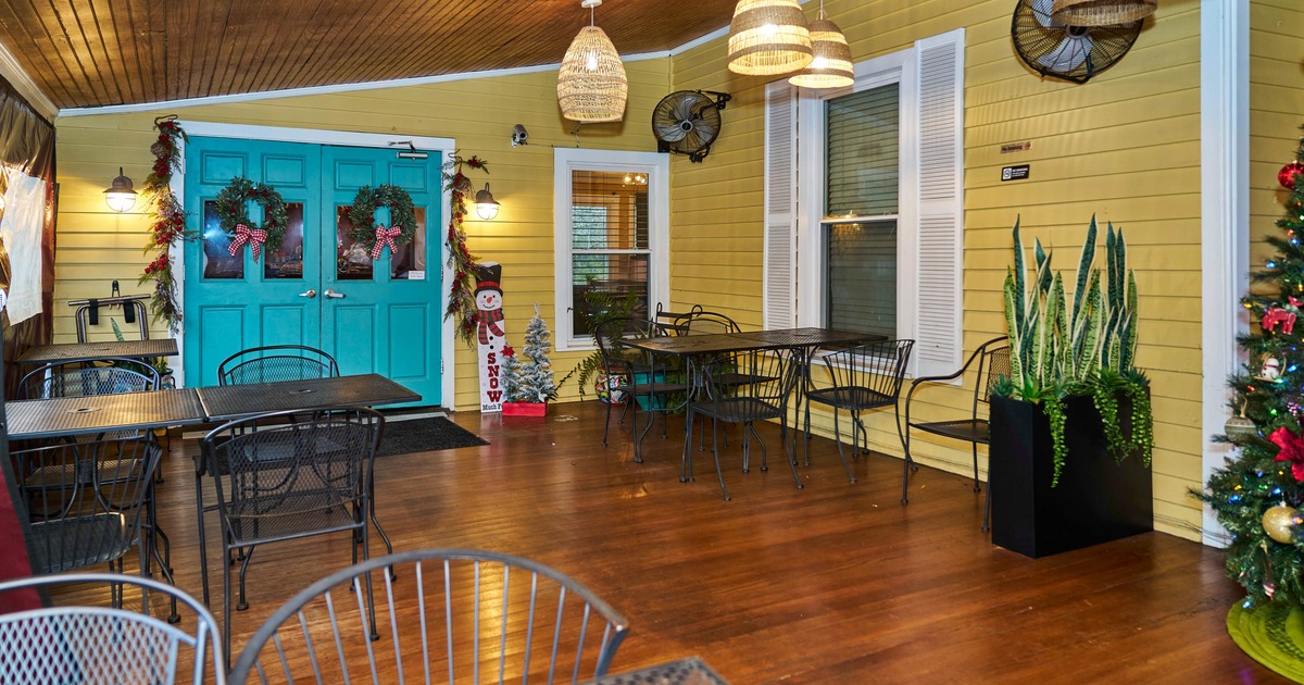 Exterior, patio, seating area, metal tables and chairs, wooden flooring, wooden doors