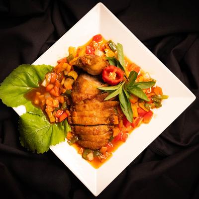 Duck meat in sweet and sour sauce, with bell peppers, and carrots.