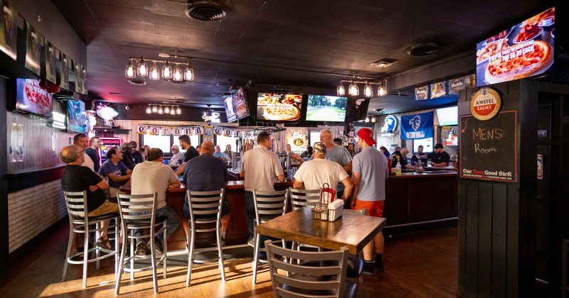 Bar, people seating, tv's above