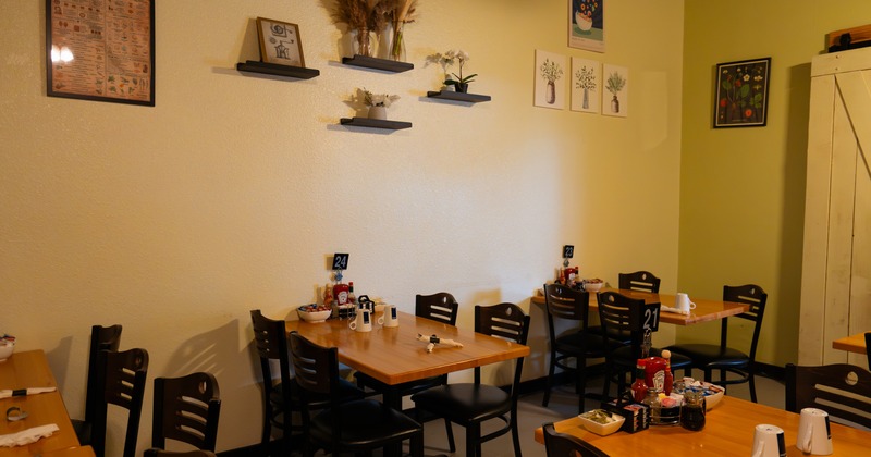Interior, dining area with wooden tables and chairs and decor on the wall